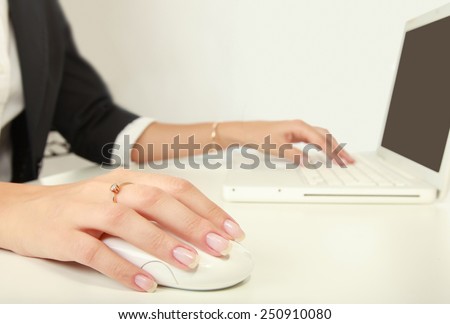 Young businesswoman working on a laptop over white background