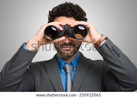 Businessman watching through binoculars