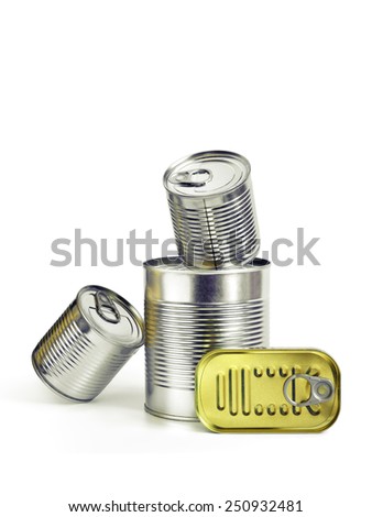 Closed cans of conserved food over a white background