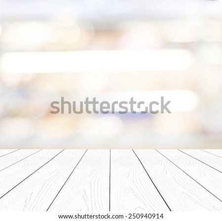 White wood table top background, Perspective wooden shelf over blur abstract bokeh light background, Empty wood counter surface and blur store, cafe, Food and product display mockup, template, banner Royalty-Free Stock Photo #250940914