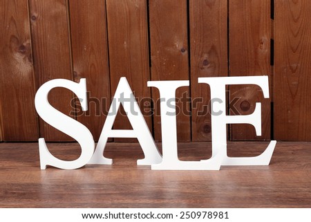 Sale on wooden background