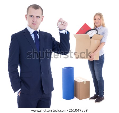 moving day concept - businessman real estate agent giving key to woman with cardboard box isolated on white background