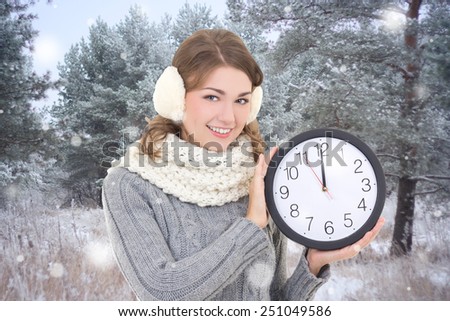 young beautiful woman with office clock in winter forest