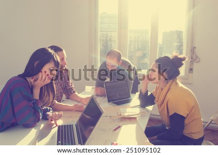 Young group of people/architects discussing business plans. Royalty-Free Stock Photo #251095102