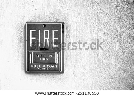 Fire alarm button on the wall black and white