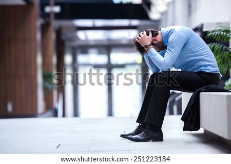 frustrated young business man working on laptop computer at office Royalty-Free Stock Photo #251223184