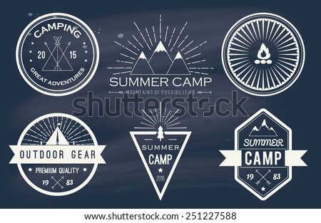Set of vintage summer camp badges and other outdoor logo's, emblems and labels on blackboard