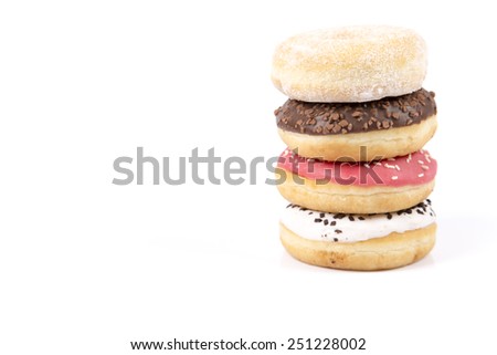 Fresh tower of donuts with icing and chocolate isolated on white backgroudn