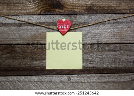 Message written on a paper hanging on the clothesline on wooden background with heart. valentines day card concept  