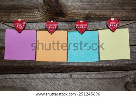 Message written on a paper hanging on the clothesline on wooden background with hearts. valentines day card concept  