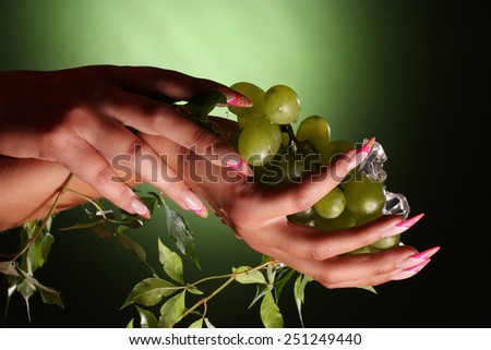 beautiful hands and nails on green background . Beautiful Female Hands.Manicure concept