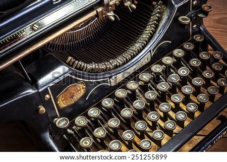 Details of an old retro typewriter, vintage style, dusty surfaces.  Royalty-Free Stock Photo #251255899