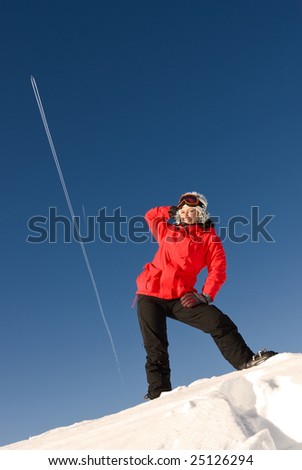 joyful woman have a fun on the top of mount at winter alpine resort in Austria