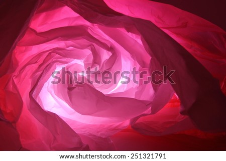 Abstract background of the insides of a red plastic bag with different color shades