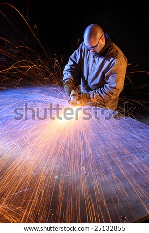 Sparks fly as man grinds metal