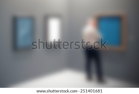 View of an ar gallery with people blurred. Intentionally blurred editing post production. Humans, location and works not recognizable.