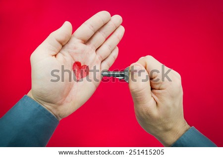 Finding the key to love suggested by a man holding a key and a heart in his palm
