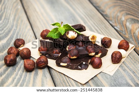 Dark  chocolate with nuts on a wooden background