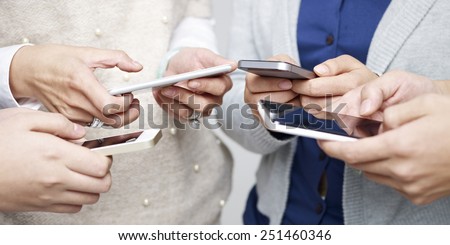 small group of people using cellphones together. Royalty-Free Stock Photo #251460346