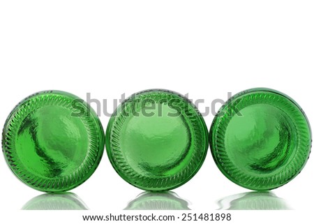 Close-up of three green color glass bottle of beers bottom for border isolated on white background.