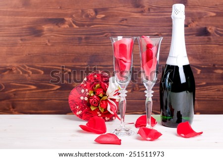 Romantic Valentine's Day with glasses with roses and hearts, champagne on  table