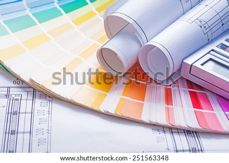 rolled blueprints on color palette 