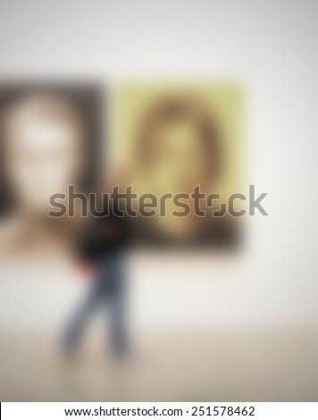 Art gallery exhibition, generic background. People, location and works not recognizable. Intentionally blurred editing post production.