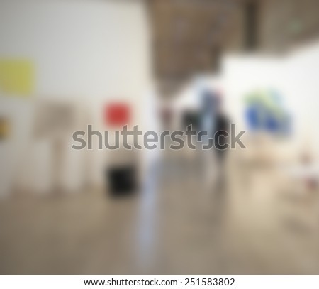 Art gallery background. Intentionally blurred editing post production. Location, people and works not recognizable.