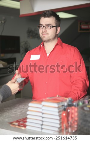 A employee of a hardware store at work.