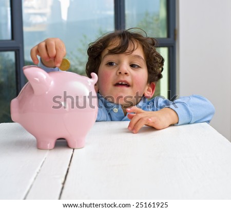 young boy holding a piggy bank