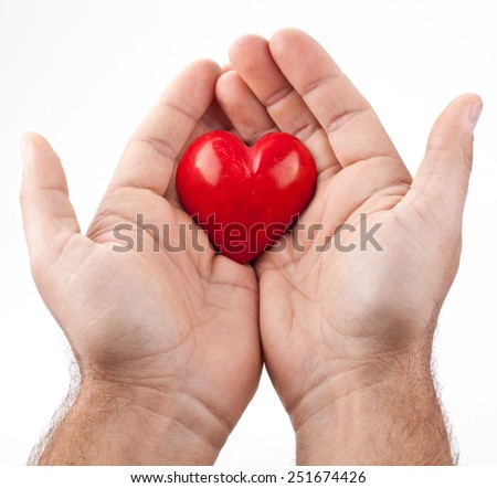 Red heart in male hands on a white background.