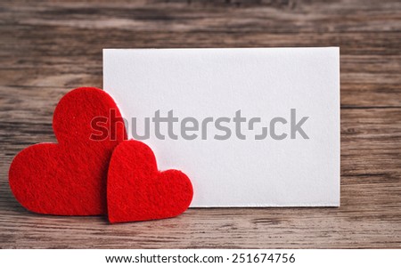 greeting card with a red hearts and space for text on a wooden background