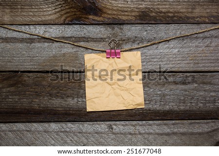 Message written on a paper hanging on the clothesline on wooden background with hearts. valentines day card concept