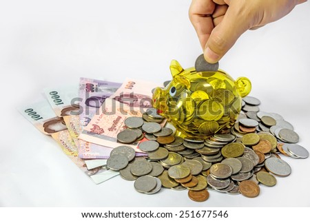  Saving, Coin with hand putting a coin into piggy bank