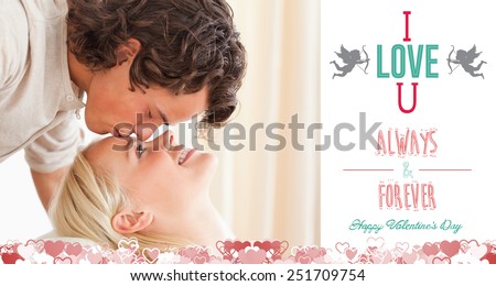 Close up of a man kissing his fiance on the forehead against i love you message