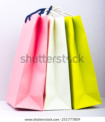 three colored packages on a gray background. Shopping. purchase