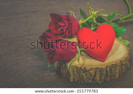 Roses on old books and glasses, small heart on wood timber, vintage style.