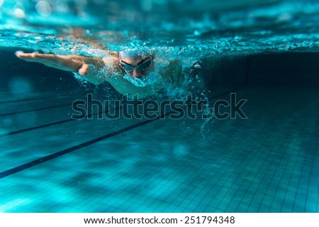 Male swimmer at the swimming pool.Underwater photo. Royalty-Free Stock Photo #251794348