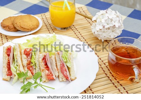 Huge breakfast with sandwich, orange juice, sweet and tea
