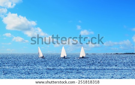 three small sail boats in a row Royalty-Free Stock Photo #251818318