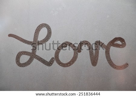 Word love written on glass 