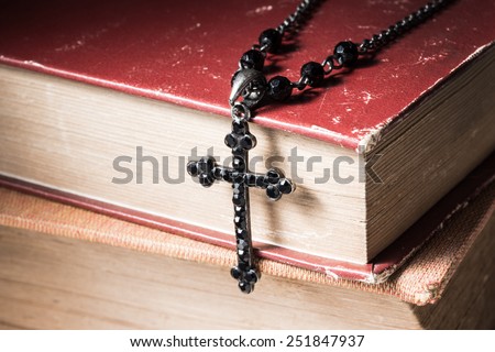 still life photography : faith concept with close up of old bible and old cross necklace