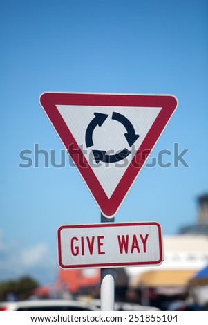 Round-a-bout roundabout give way warning sign vertical with space for copy.