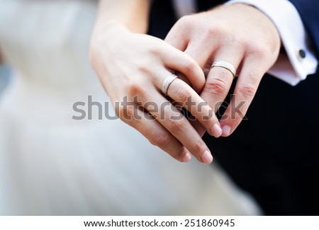 Newly wed couple's hands with wedding rings Royalty-Free Stock Photo #251860945