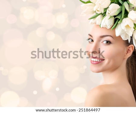 Portrait of beautiful young woman with flowers in hair