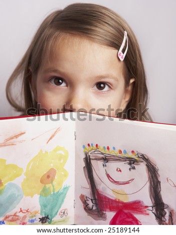 shy girl hiding behind her drawing