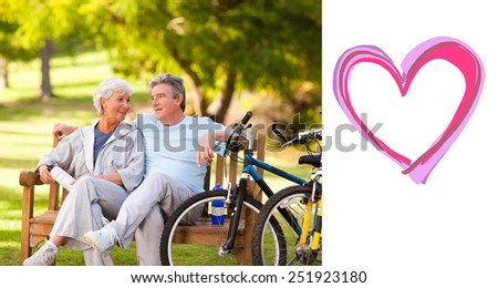 Elderly couple with their bikes against heart
