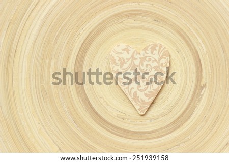 love symbol over texture of bamboo plate