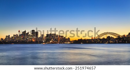 australia Sydney city CBD panoramic view with Harbour bridge at sunset with illuminated skyscrapers and blurred water