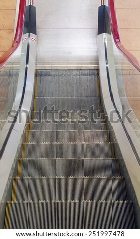 Metal stairs of new moving escalator in modern shopping center